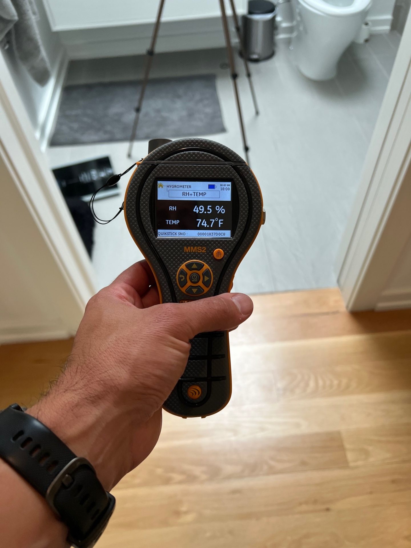 HB&H inspector using a Protimeter MMS2 hygrometer to measure humidity and temperature during a New York City bathroom mold inspection